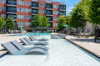 Industrial style swimming pool with shipping container cabanas